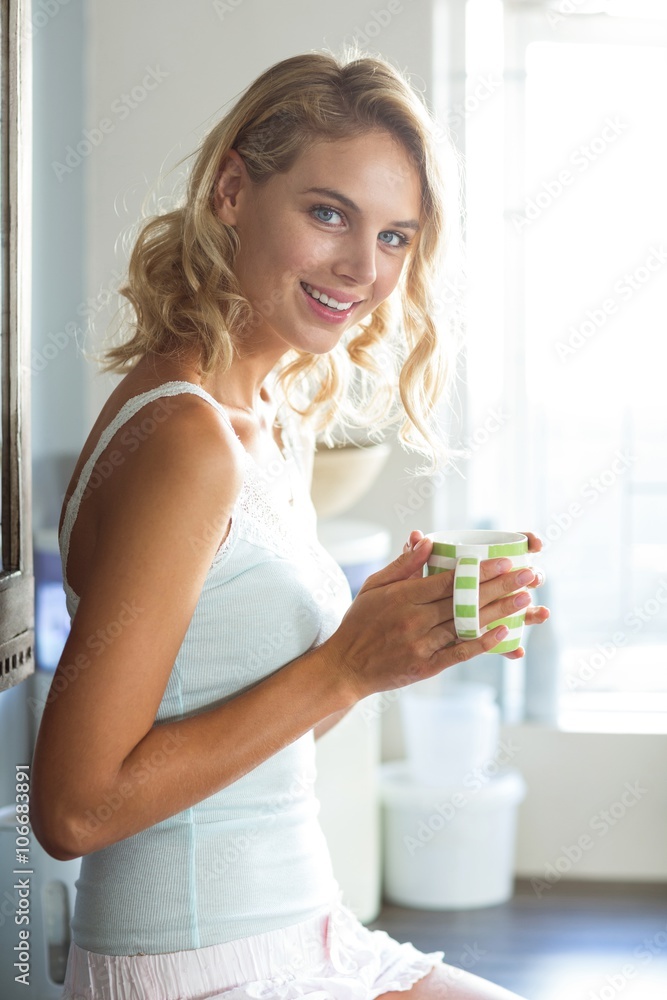 Beautiful woman smiling while having coffee at home Beautiful woman smiling while having coffee at home