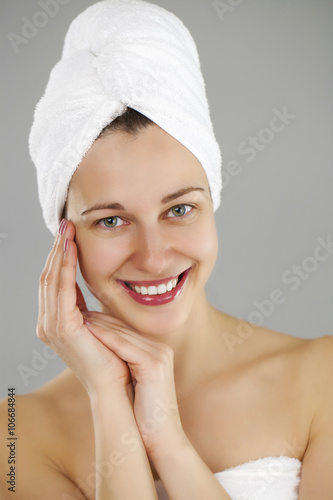 Beautiful young woman posing in white towel