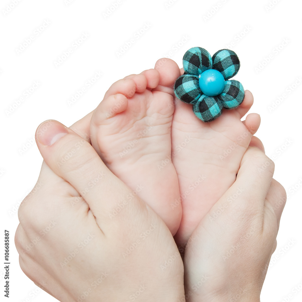 little baby feet with blue flower in the mother's hands.Small nice toes little baby feet with blue flower in the mother's hands.Small nice toes