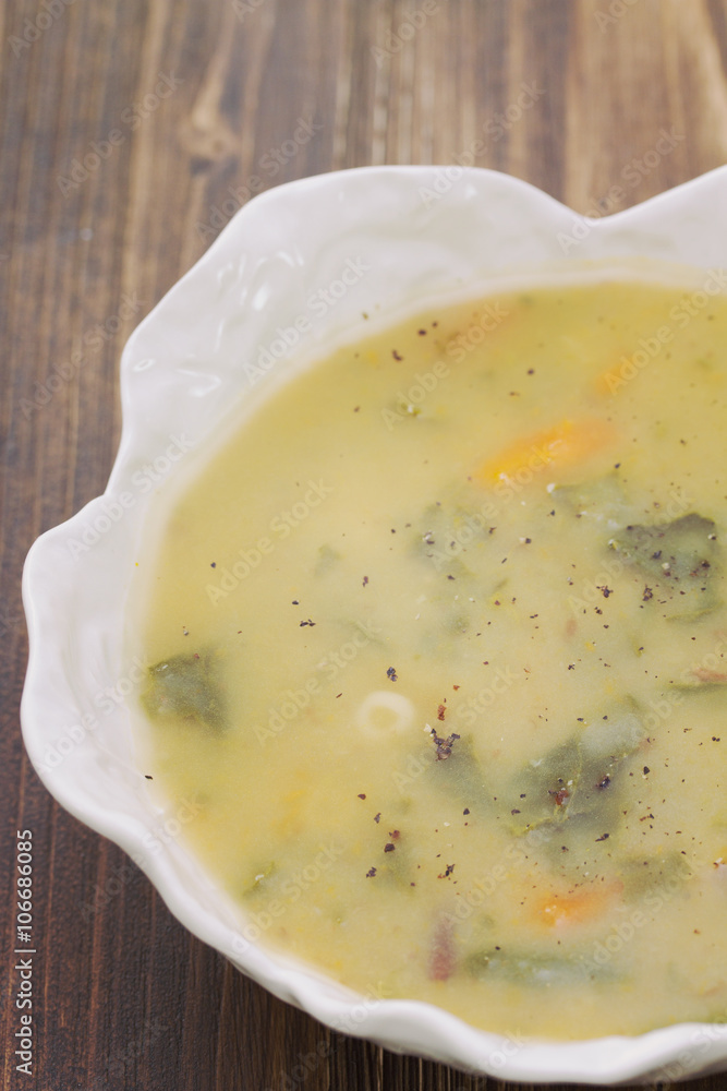 vegetable soup in white bowl on brown wooden background vegetable soup in white bowl on brown wooden background
