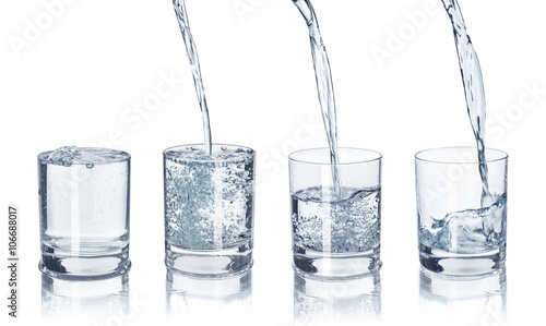 a set of glasses with water on an isolated white background