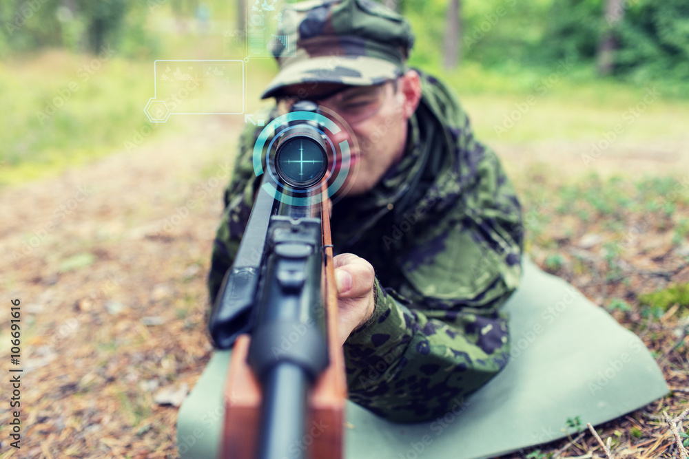 close up of soldier or sniper with gun in forest