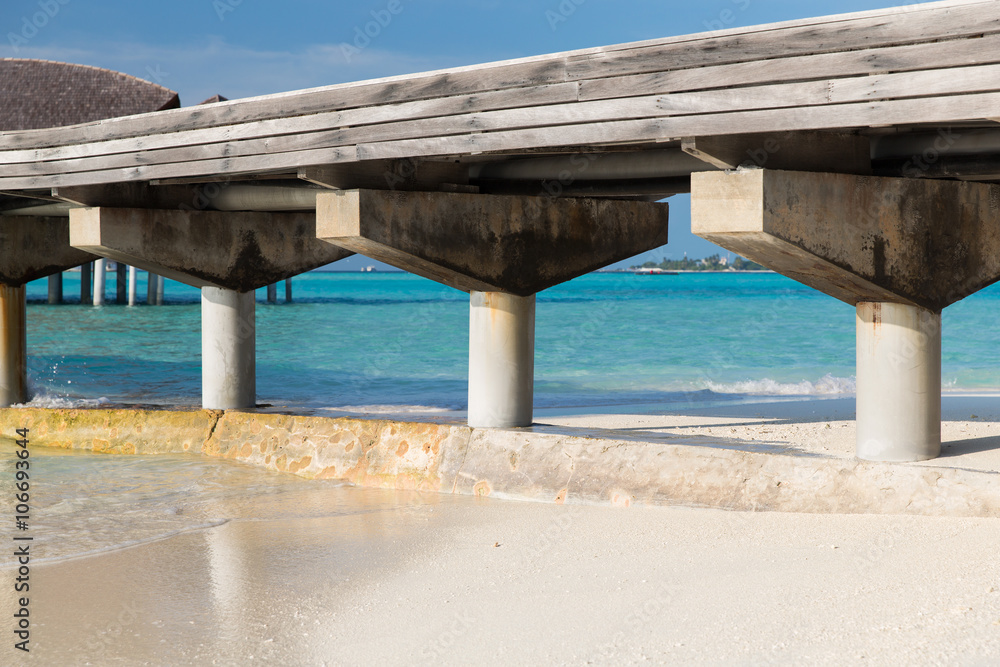 bridge on stilts at exotic resort beach