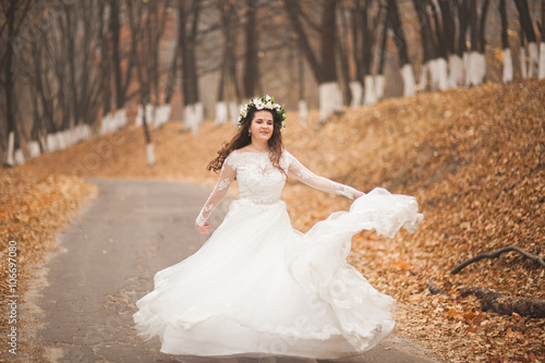 Beautiful bride posing in park and forest autumn