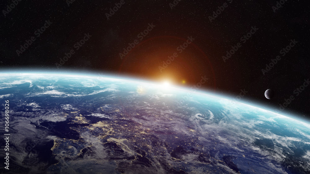 Naklejka premium Wschód słońca nad planetą Ziemia w przestrzeni