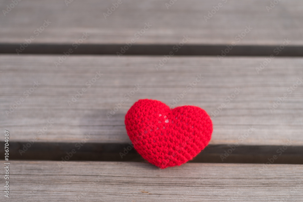 Fototapeta premium Crocheted heart on a wooden board