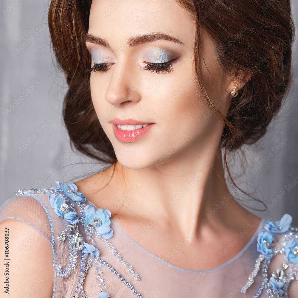 Close-up portrait of beautiful young woman in luxury dress, pastel color. Beauty fashion portrait