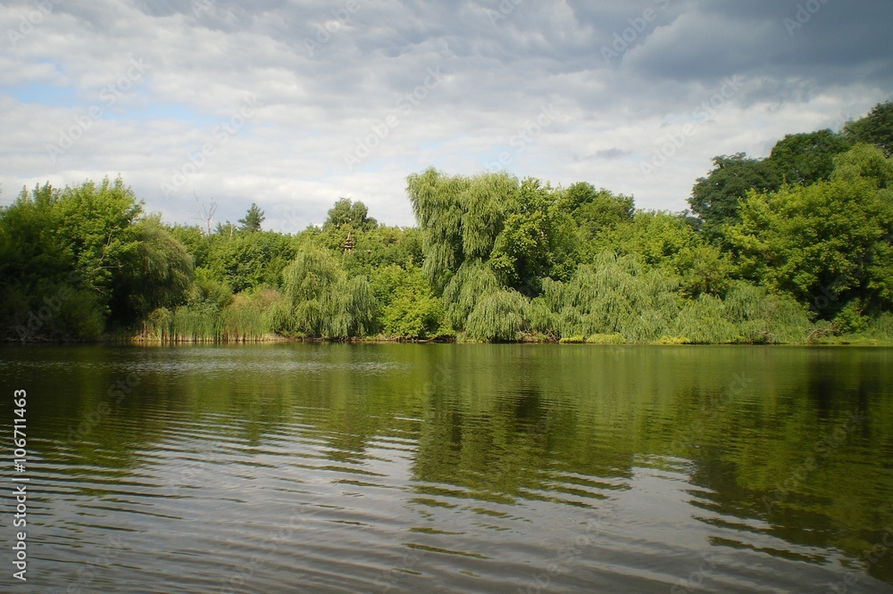 The landscape, consisting of a river, trees and sky. The landscape, consisting of a river, trees and sky.
