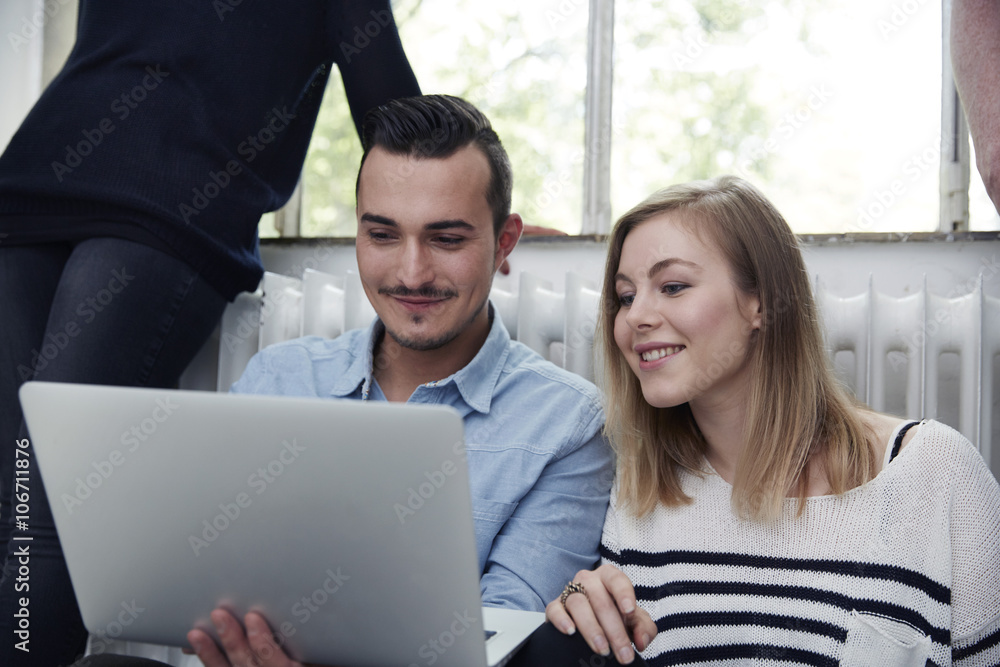 Smiling man and woman using laptop Smiling man and woman using laptop