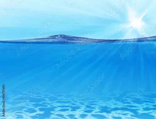 Blue sky, sun, solar beams, sea background under water © assistant