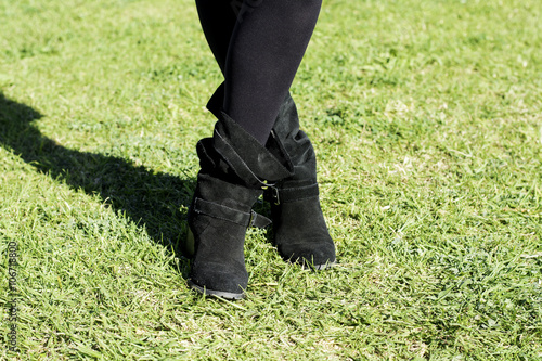 boots of woman on lawn
