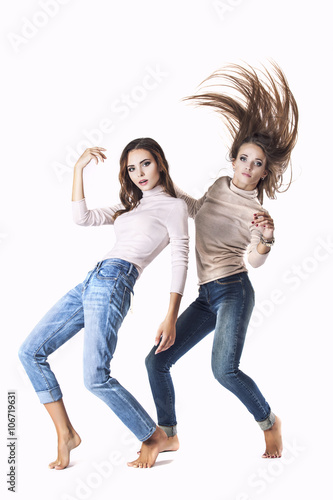 Women are two models in fashionable clothes in jeans in the Stud