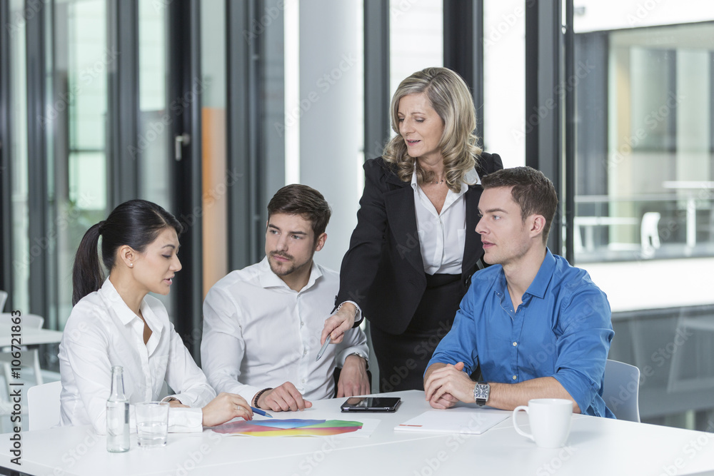 Meeting of four business people in a conference room Meeting of four business people in a conference room