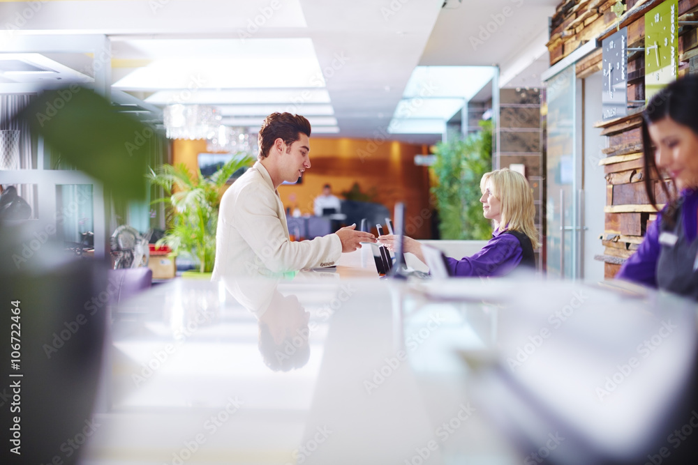 Businessman arriving at hotel reception Businessman arriving at hotel reception