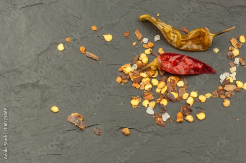 Dried chili peppers on dark slate. Strong spices for spicy foods. Decorate the kitchen. Place for your text. Creating the menu.
