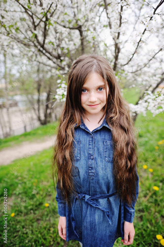 Kid girl in blooming garden Kid girl in blooming garden