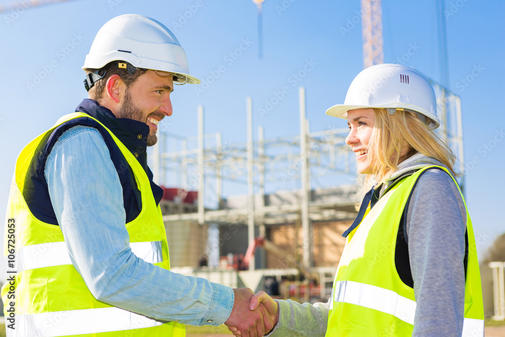 architect and worker handshaking on construction site architect and worker handshaking on construction site
