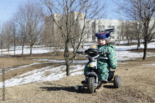 Pensive toddler on bike