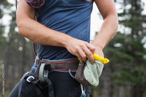 Midsection of man with chalk bag photo