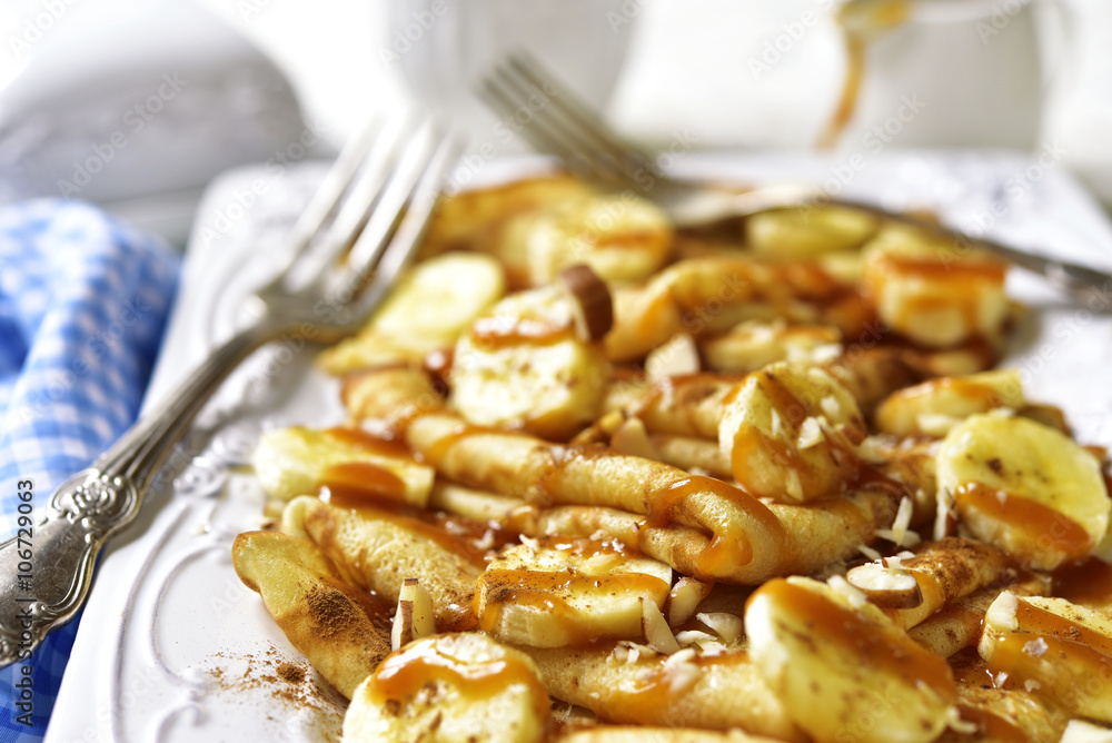 Pancakes with banana,caramel,nuts and cinnamon.