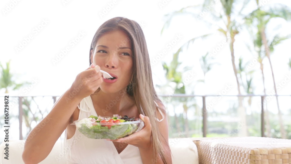 Healthy lifestyle woman eating salad smiling happy outdoors on beautiful day. Young female eating healthy food outside in summer dress laughing and relaxing in sofa. Pretty multiracial model. Healthy lifestyle woman eating salad smiling happy outdoors on beautiful day. Young female eating healthy food outside in summer dress laughing and relaxing in sofa. Pretty multiracial model.
