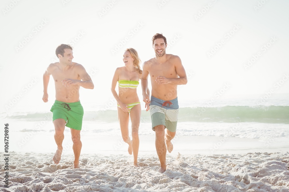 Happy friends running on the beach Happy friends running on the beach