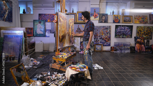 In the process of creating a masterpiece. A professional artist working in his studio.