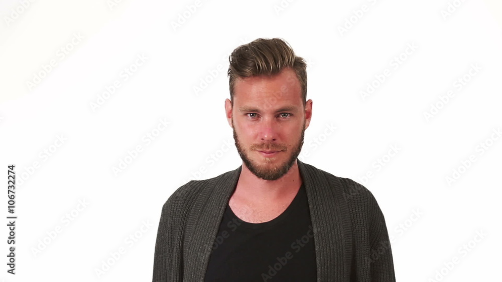 A man in his 20s wearing a grey sweater and black tshirt, walking in front of camera, stopping and turns to camera. White background. A man in his 20s wearing a grey sweater and black tshirt, walking in front of camera, stopping and turns to camera. White background.