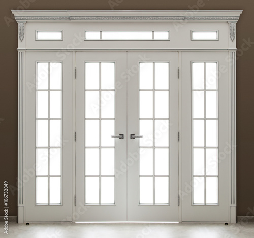 A white decorated  double door with glass