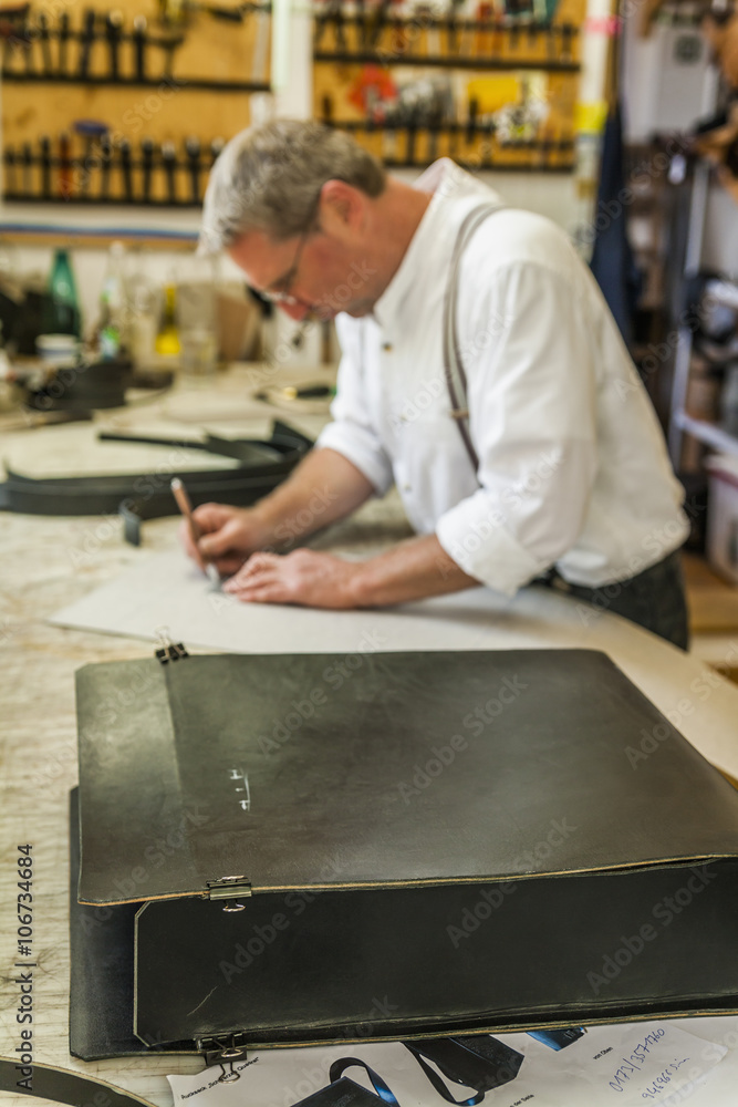 Saddler preparing stencil for rucksack Saddler preparing stencil for rucksack