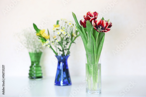 Bouquets of fresh flowers on white background