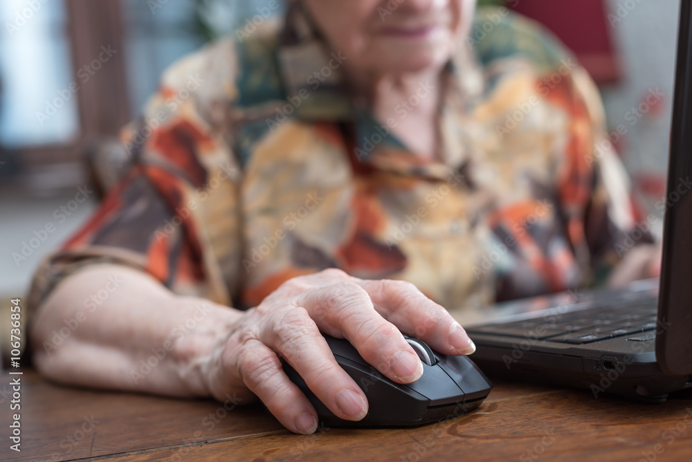 Senior hand using the mouse of a computer Senior hand using the mouse of a computer