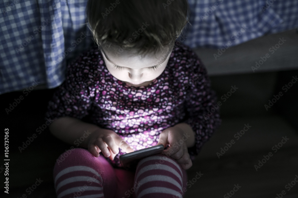 Toddler sitting on the floor playing with smartphone Toddler sitting on the floor playing with smartphone