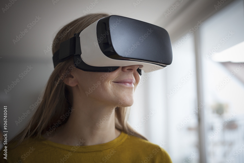Smiling woman wearing Virtual Reality Glasses Smiling woman wearing Virtual Reality Glasses
