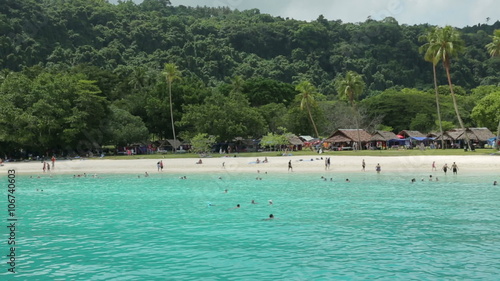 Tourists on tropical beach at Champagne bay, Vanuatu photo