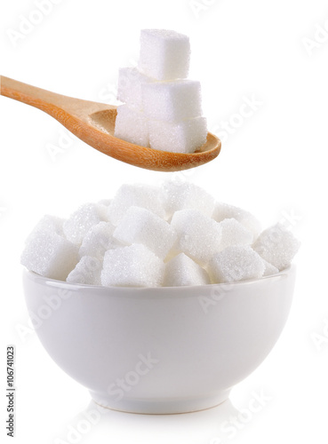 sugar cube in the bowl and wood spoon on white background