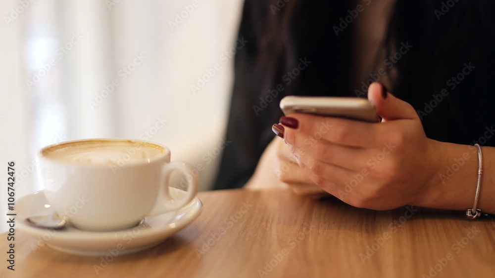 Close up of female hands using mobile phone on a cafeteria . Close up of female hands using mobile phone on a cafeteria .