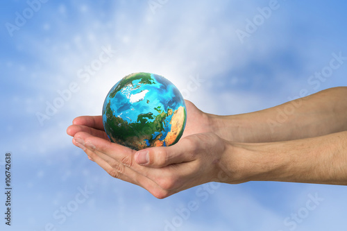 Human hand holding globe