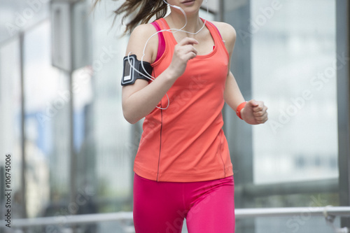 Young woman jogging with smart watch photo