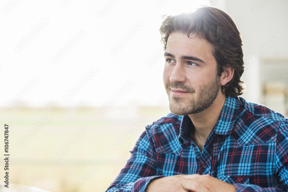 Portrait of relaxed man with brown hair wearing checked shirt Portrait of relaxed man with brown hair wearing checked shirt