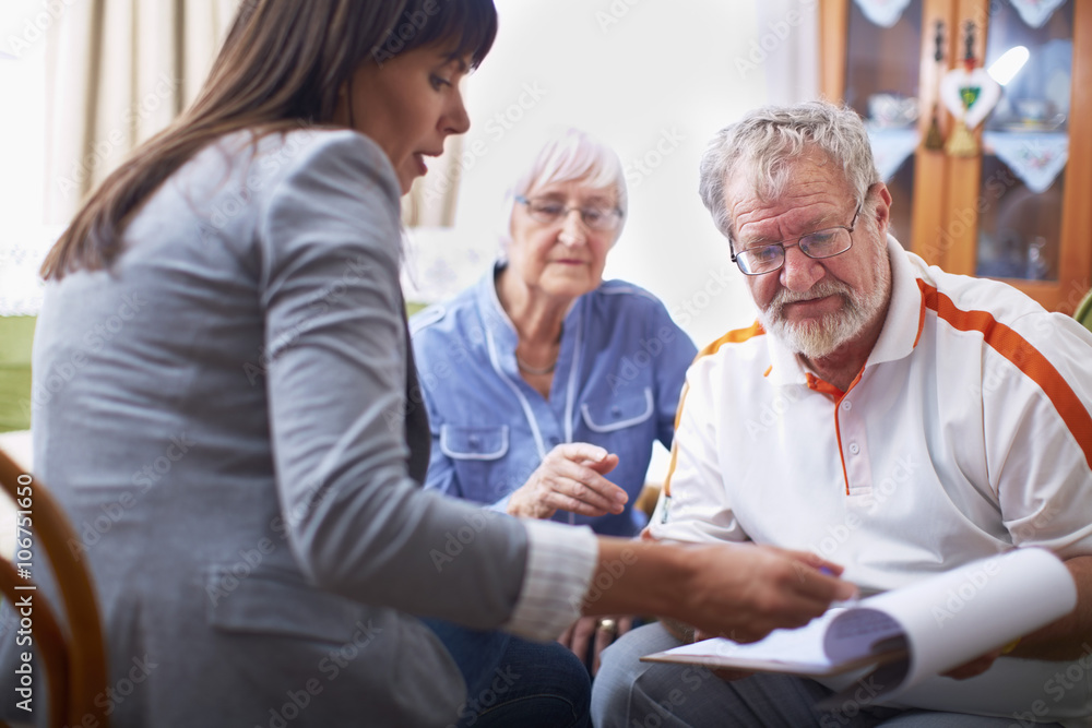 Woman explaining document to senior couple Woman explaining document to senior couple
