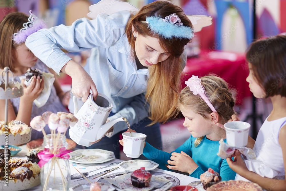 Girls and teenage girl on a tea party Stock Photo | Adobe Stock