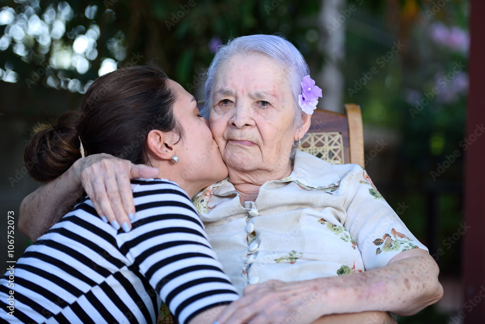 Grandaughter kissing grandma