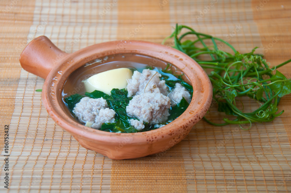 Ivy gourd soup with minced pork and egg tofu on mat Ivy gourd soup with minced pork and egg tofu on mat