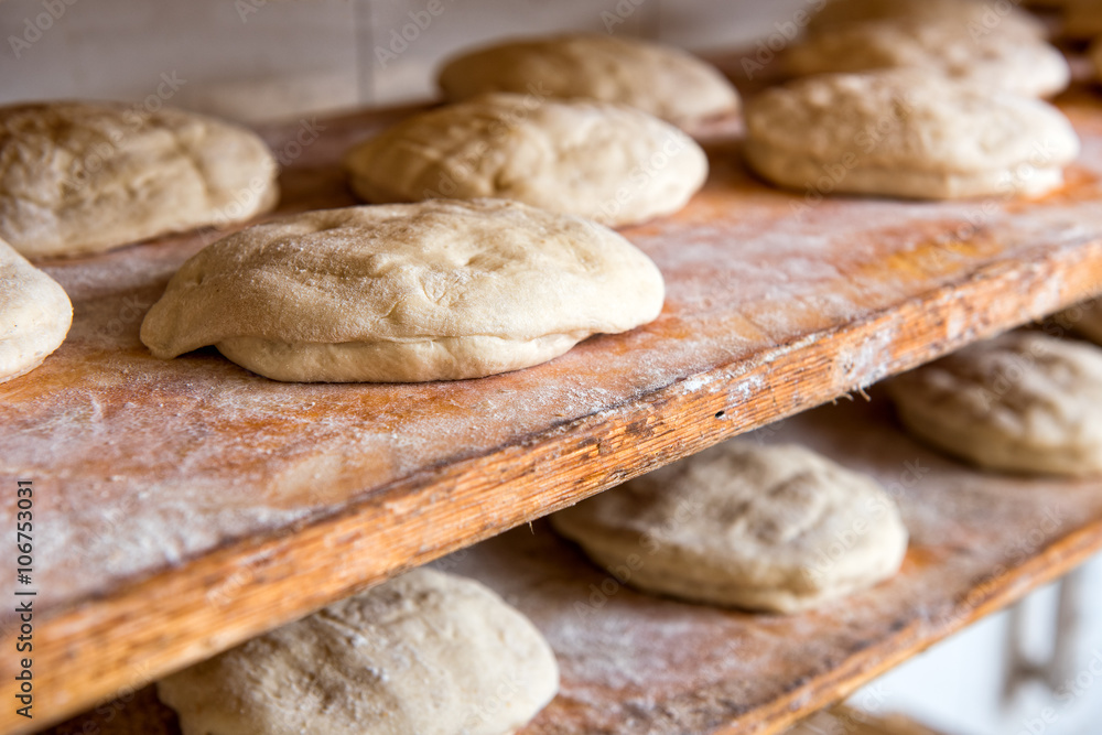Prepared raw bread dough shaped into loaves