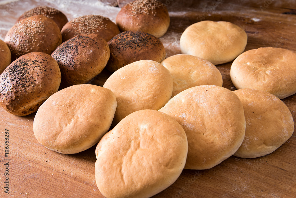 Assorted flat bread rolls on display Assorted flat bread rolls on display