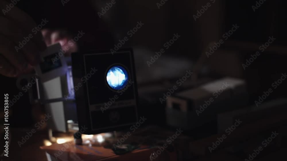 Man shows photos on the slide projector Man shows photos on the slide projector