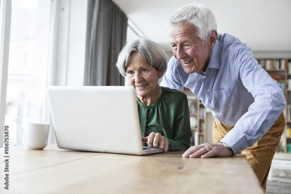 Senior couple using laptop at home Senior couple using laptop at home