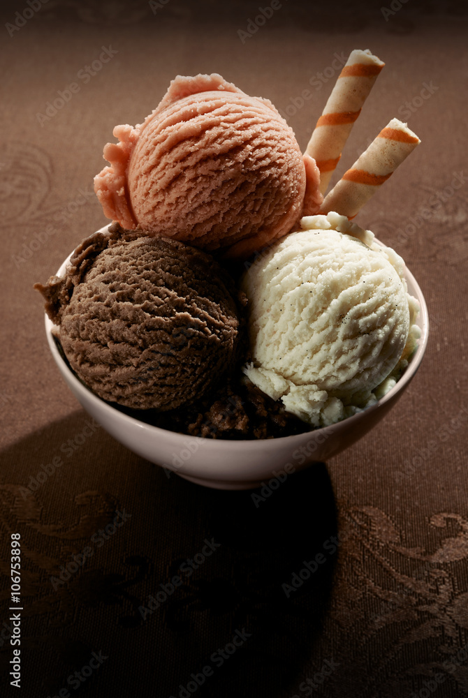 Fototapeta premium Bowl of frozen dessert on a brown background