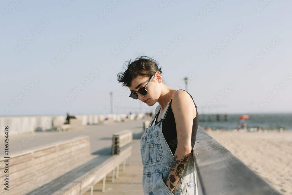 USA, New York, Coney Island, young woman relaxing at beach promenade USA, New York, Coney Island, young woman relaxing at beach promenade